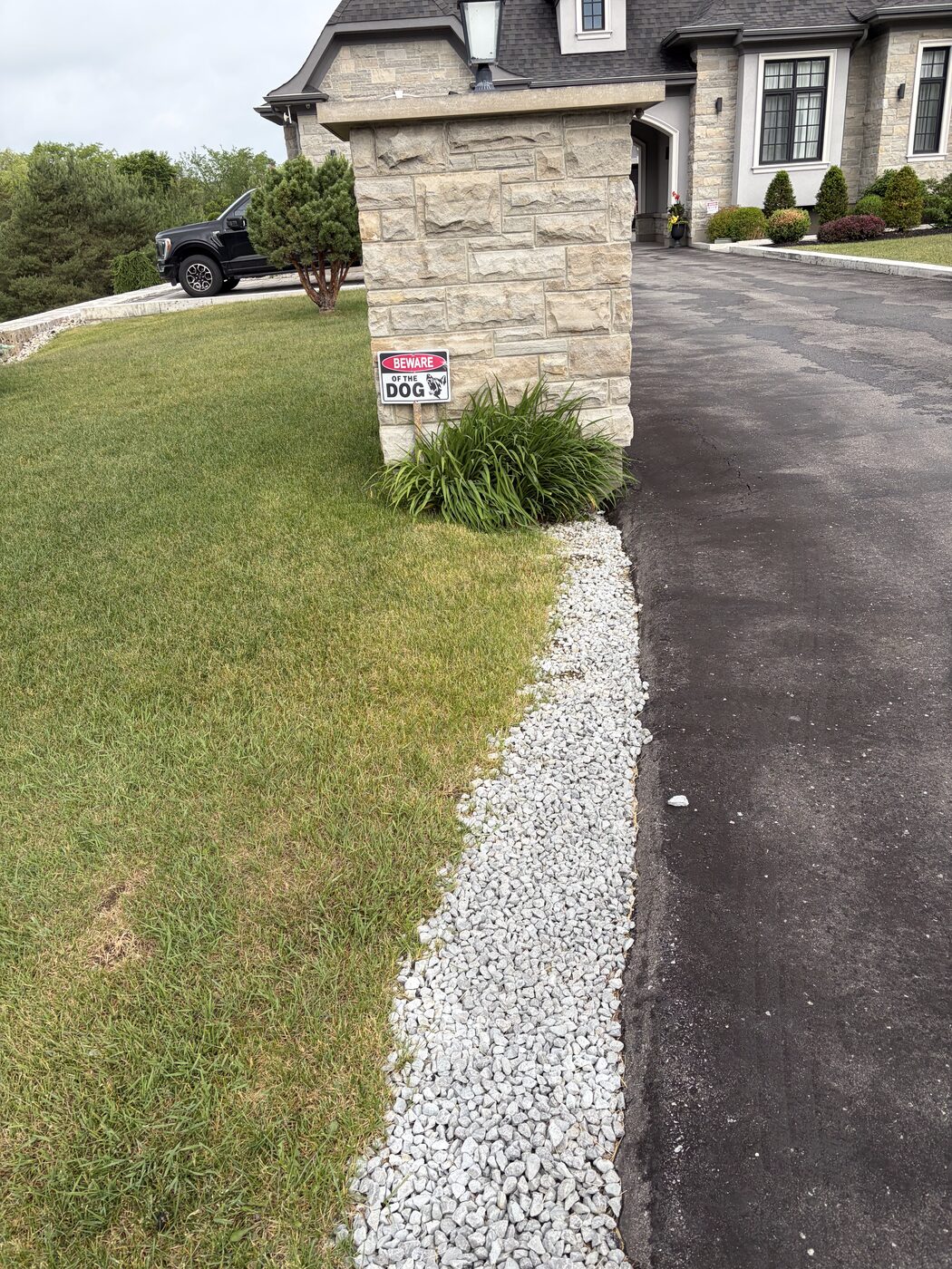 Crisp white gravel border along a paved driveway
